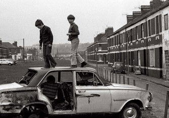 Boys playing on an abandoned car, Newport, 1974. Robin Weaver/Alamy.