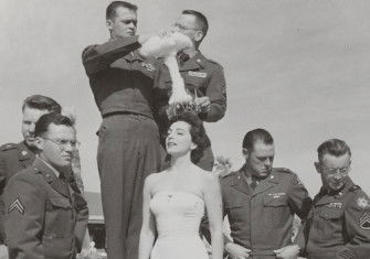 Servicemen crown a Copa Room showgirl ‘Mis-Cue’ to mark the misfiring of the Operation Cue Bomb at Sands Hotel and Casino, Las Vegas, 1955. UNLV University Libraries Special Collections and Archives.