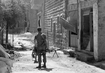 An Israeli soldier patrols the Syrian town of Majdal Shams in the Golan Heights, 1969. National Library of Israel (CC BY).
