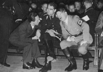 Adolf Hitler in conversation with minister of propaganda Joseph Goebbels and deputy fuhrer Rudolf Hess, December 1933. Potemkowska Aleksandra. Public Domain.
