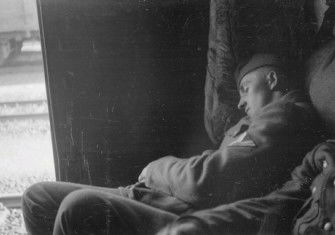 A German soldier sleeps in a railway wagon on his way to the Eastern Front, by Franz Grasser, 1943. Deutsche Fotothek. Public Domain.