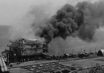 An Iranian oil platform burns after being hit by the US Navy in retaliation for the mining of USS Samuel B. Roberts, 18 April 1988. National Archives and Records Administration. Public Domain.