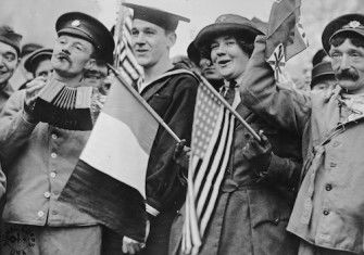 Two wounded British soldiers, a sailor, and an American Red Cross volunteer celebrate the Armistice in Paris, 11 November 1918. Library of Congress.