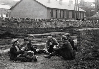 Striking workers playing cards, May 1926. Hulton/Getty Images.