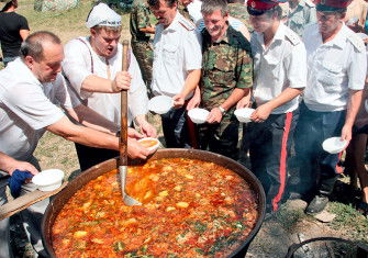 Don Cossacks in army uniform wait in line for borscht, 2006.