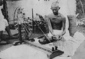 Mahatma Gandhi spinning yarn, in the late 1920s
