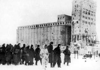 German soldiers as prisoners of war. In the background is the heavily fought-over Stalingrad grain elevator