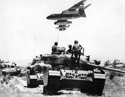 An Israeli Vautour  bomber flies over tanks assembling in the Negev desert on May 24th,  1967, two weeks before the outbreak of the  Six Day War.  © Topfoto