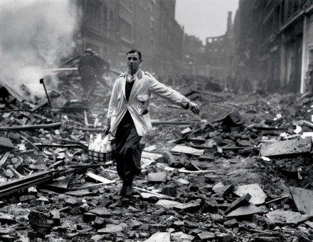 Staged photograph of a ‘milkman’ in a street devastated by a German bombing raid, Holborn, London, 10 September 1940.