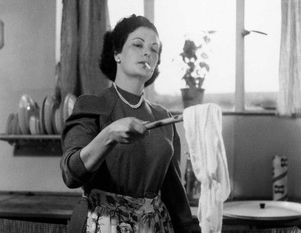 A woman doing the laundry while smoking, 1954.