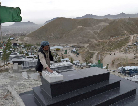 Graveyard of history: an Afghan man prays at the tomb of a relative, Shuhada cemetery, Kabul.