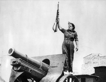 Woman with a rifle near a canon. Spanish civil war. Barcelona, 1936.