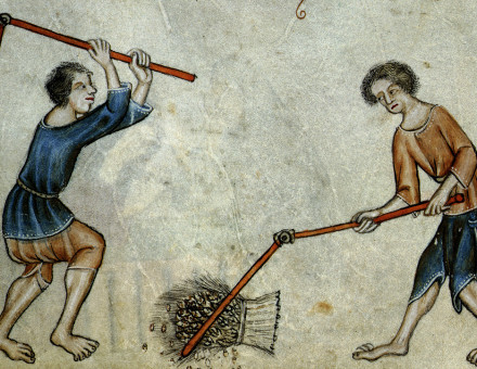 Two men threshing sheaf