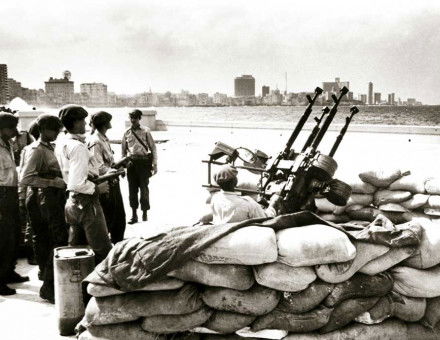 Cuban soldiers stand by an anti-aircraft gun, Havana, 1962.