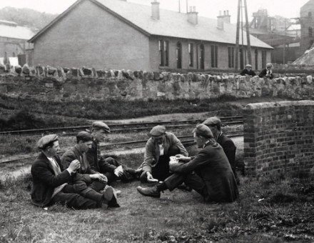 Striking workers playing cards, May 1926. Hulton/Getty Images.