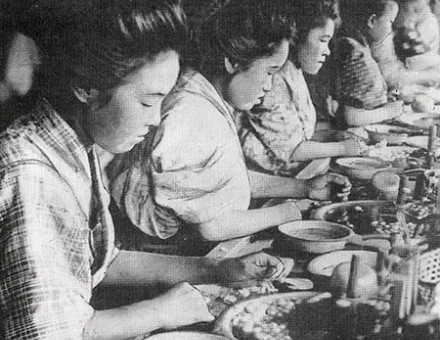 Girls preparing cocoons in hot water for spinning silk.