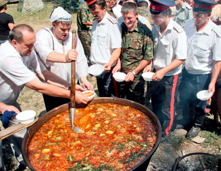 Don Cossacks in army uniform wait in line for borscht, 2006.