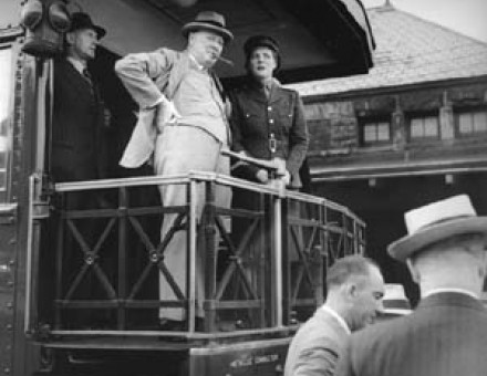 Walter Thompson standing behind Churchill on a train on a speaking tour of the US