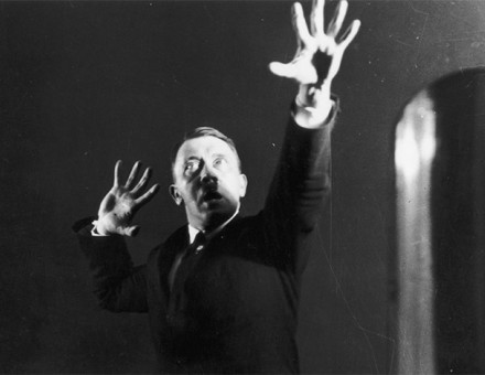 Hitler miming gestures to a record of his speeches; one of an extraordinary series of photographs he commissioned in 1925 to aid self-analysis and improve his hold over an audience.