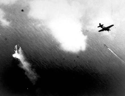  U.S. aircraft, such as this Curtiss SB2C-3 Helldiver, begin their attacks on Yamato (center left). A Japanese destroyer is in the center right of the picture.