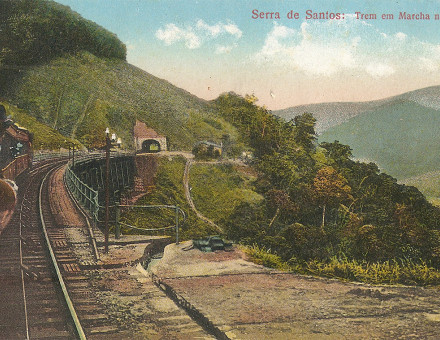 A hand-coloured postcard of an SPR train descending to the mouth of a tunnel.