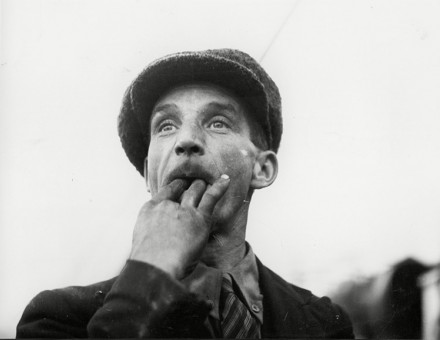 A foreman whistles a signal to a crane driver, 1938.