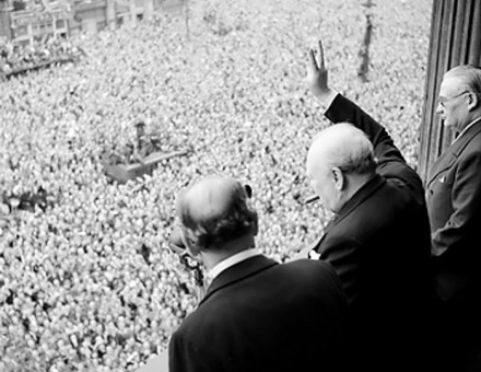 Winston Churchill waves to crowds in Whitehall, May 8th, 1945.