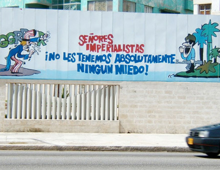 Cuban propaganda poster in Havana featuring a Cuban soldier addressing a threatening Uncle Sam.