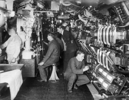The interior of a British E-class submarine. An officer supervises submerging operations, c. 1914–1918.