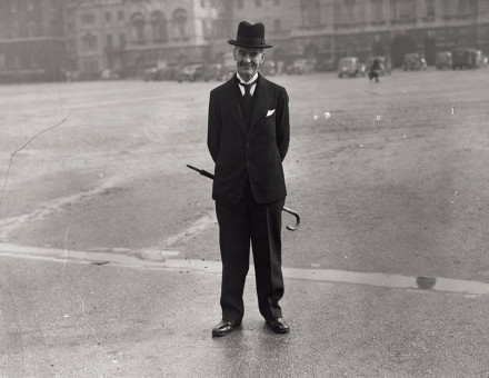 Neville Chamberlain stands, with his umbrella, on Horse Guards Parade, off Whitehall, London, 18 March 1940. 